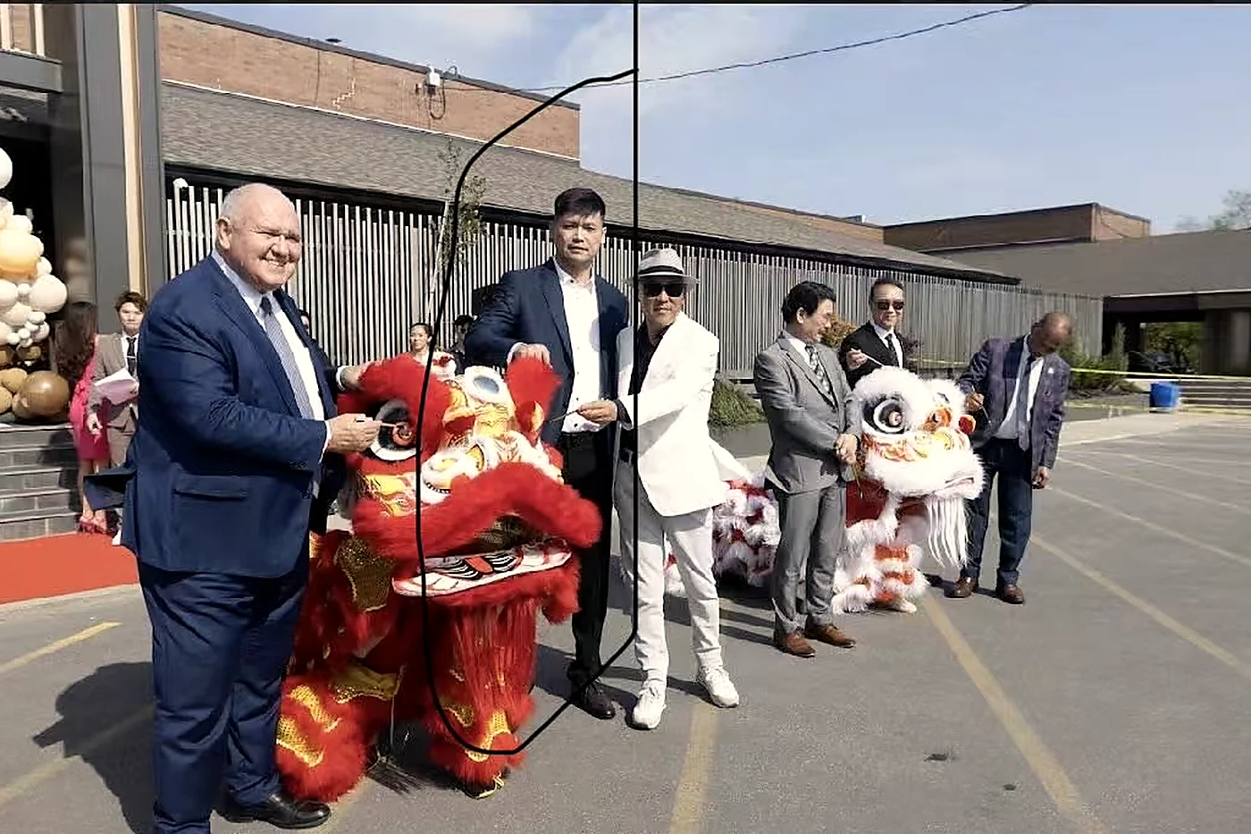A red and gold lion dance costume greeting guests
