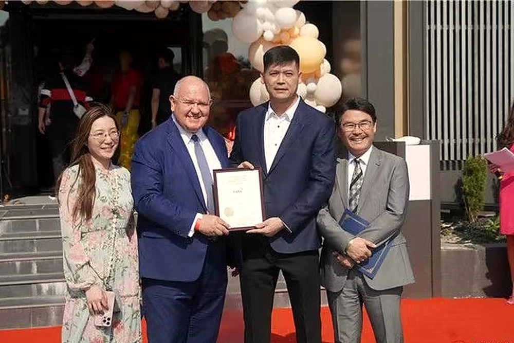Four guests holding a certificate of recognition